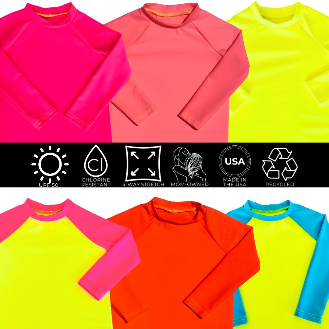 Lay flat photos of  baby swimwear and toddler swimwear. On top is a neon pink and neon yellow toddler long sleeve rash guard. Below that toddler sun shirt is a neon coral toddler long sleeve swim shirt, then a neon pink baby long sleeve rash guard, then a neon yellow toddler long sleeve rash guard, and then a neon orange toddler boys rash guard.